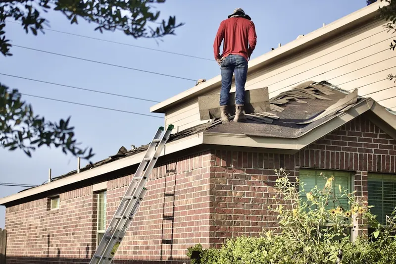 Professional roofer working on a residential roof in Nottingham Woods
